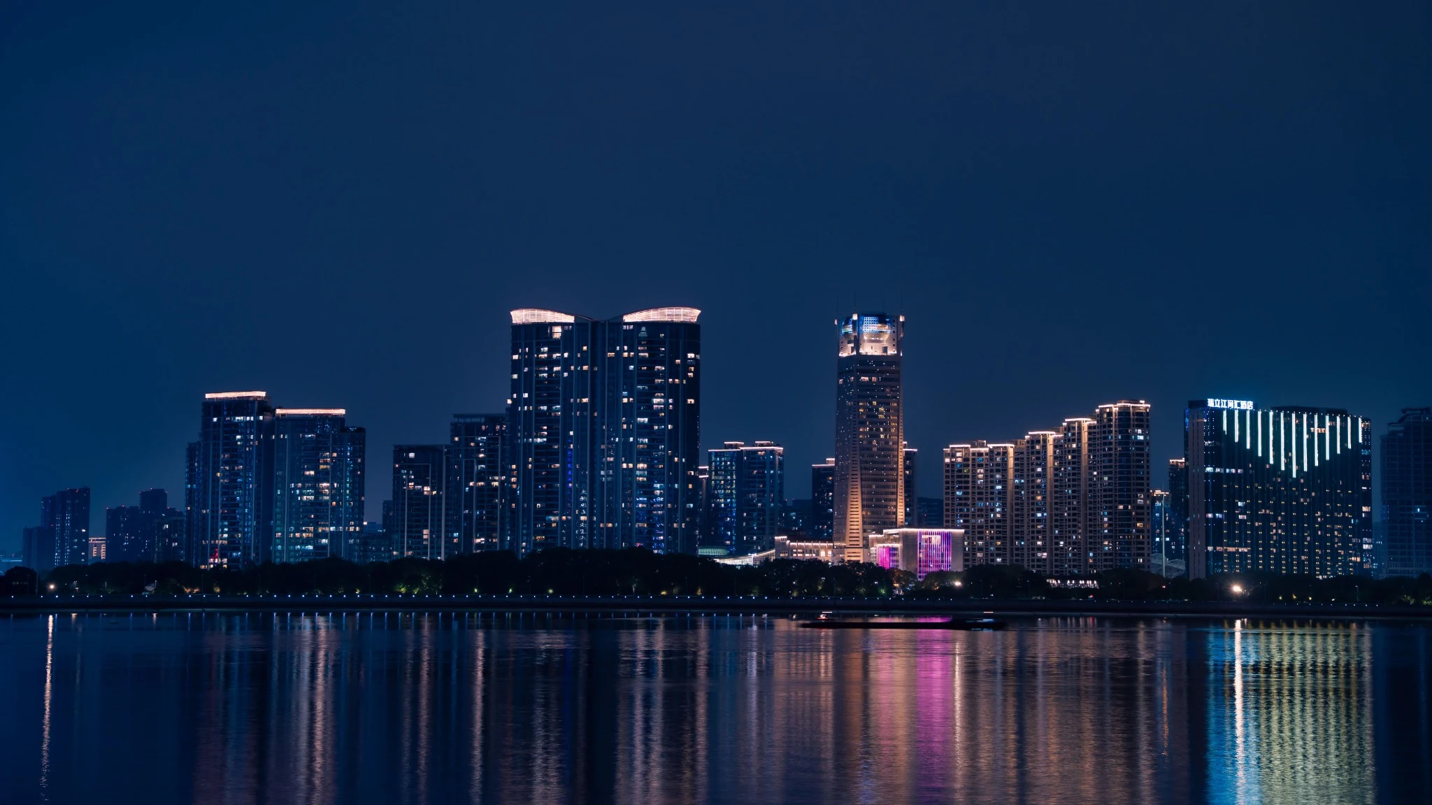 Illuminated waterfront buildings at night